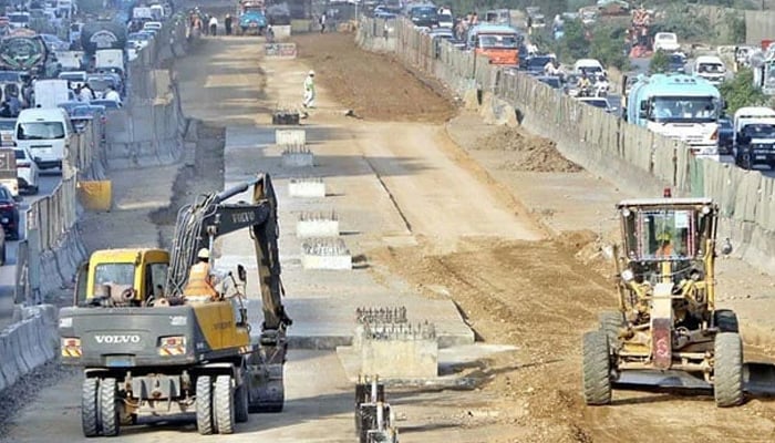 Heavy machinery being used during the development work at University Road in Karachi on September 25, 2024. — APP