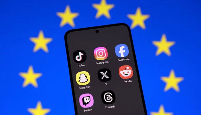 An EU flag and smartphone with displayed social media app icons in this illustration taken February 3, 2026. — Reuters