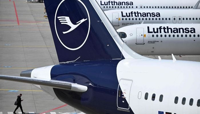 The logo of German airline Lufthansa is seen on several aircraft on the tarmac at Frankfurt Airport, Frankfurt am Main, western Germany, on April 15, 2026. — AFP