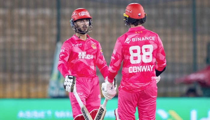 Islamabad Uniteds Sameer Minhas (left) and Devon Conway interact during the PSL match against Karachi Kings at National Bank Stadium, Karachi, on April 16, 2026. — PSL