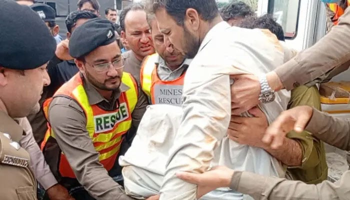 Rescue 1122 officials rescue a man from under the debris at the site of a mine collapse in KP’s Mardan on April 16. — Rescue 1122