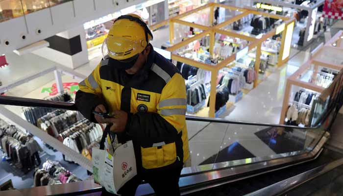 A Meituan delivery worker picks up a food order at a shopping mall in Beijing, China October 17, 2024.— Reuters/File