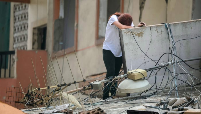 A displaced woman reacts after returning to her damaged home in Beirut, Lebanon on April 18, 2026. — AFP