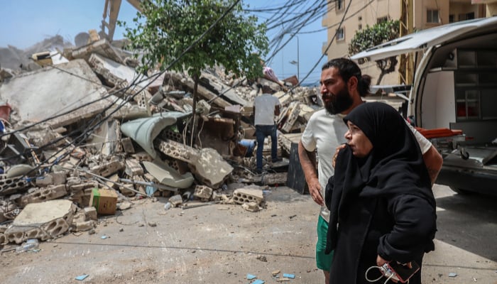A woman reacts as emergency personnel search for survivors at the site of an Israeli strike carried out in Tyre, Lebanon, April 17, 2026. — Reuters