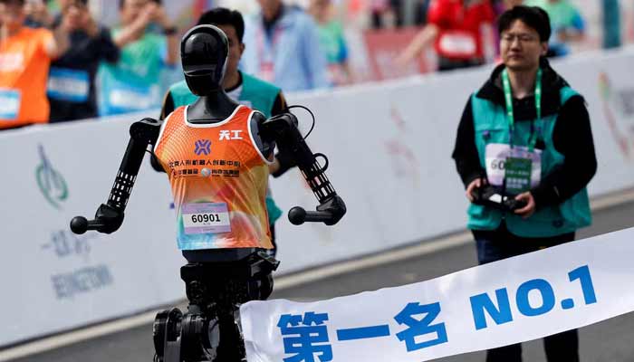 Tiangong Ultra, a humanoid robot, runs across the finish line while securing the first position during the E-Town Humanoid Robot Half Marathon, in Beijing, China, April 19, 2025.— Reuters