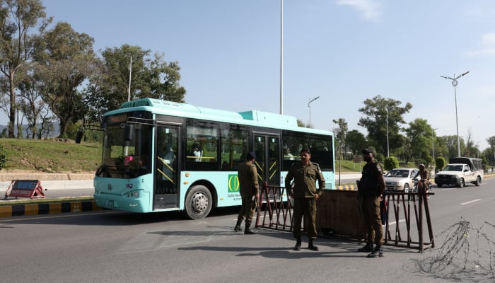A bus moves past a security checkpoint along a road, as Pakistan prepares to host the US and Iran for the  potential second phase of peace talks in Islamabad, Pakistan April 19, 2026. — Reuters