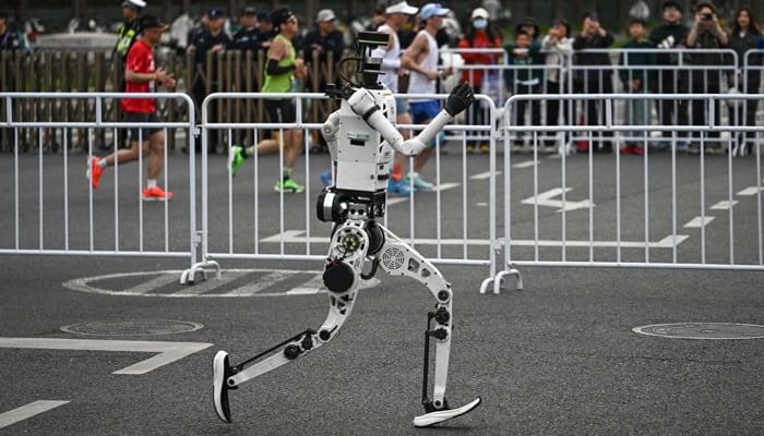 A robot runs in the second Beijing E-Town Half Marathon and Humanoid Half Marathon in Beijing on April 19, 2026. — AFP