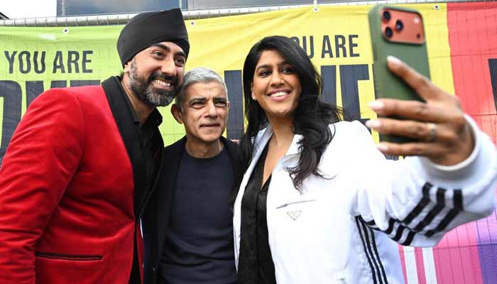 London Mayor Sadiq Khan (centre) poses for a picture with participants of Vaisakhi festival in Trafalgar Square, London, April 19, 2026. — Reporter
