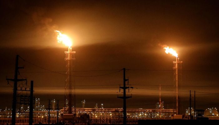 Gas flares at an oil refinery near Iraqs receding marshes of Hawizeh, which straddle the border with Iran, in the southeastern Missan province on April 25, 2025. — AFP