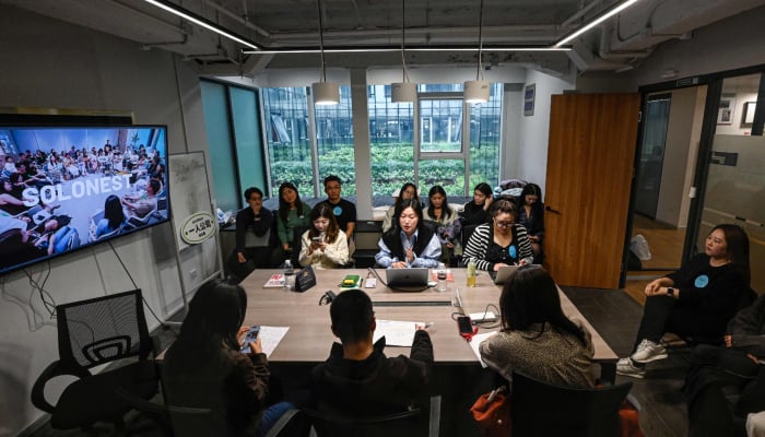 The photo taken on April 12, 2026 shows founder of one-person company SoloNest Karen Dai sharing her experience with participants during a coffee chat at a conference room in Shanghai, China. — AFP