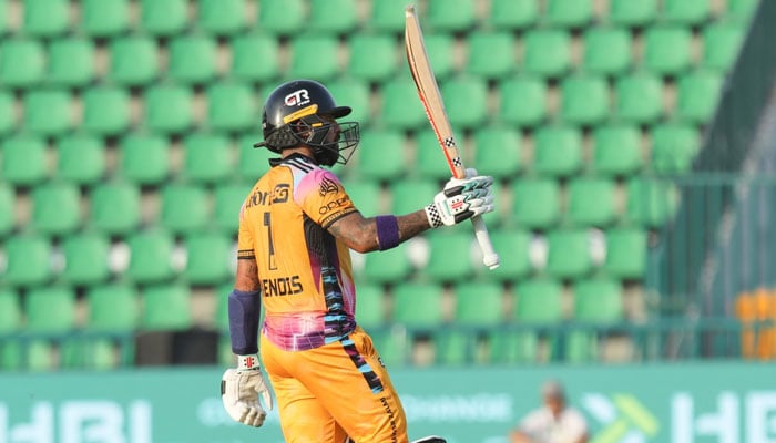 Peshawar Zalmis Kusal Mendis raises his bat after scoring half-century during the PSL match against Karachi Kings at Gaddafi Stadium, Lahore, on April 22, 2026. — PSL