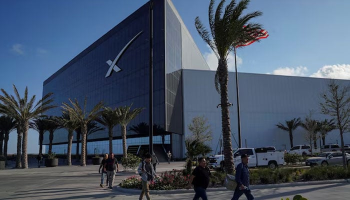 People walk in front of SpaceX’s facilities in Starbase, Texas, the US, March 25, 2026 — Reuters