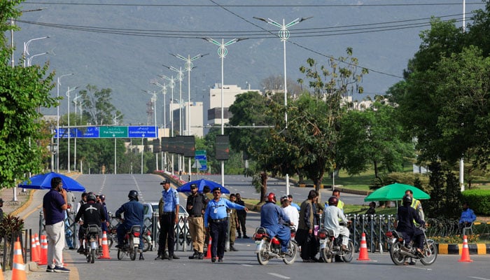 Police officers divert traffic on road in Islamabad, April 23, 2026. — Reuters