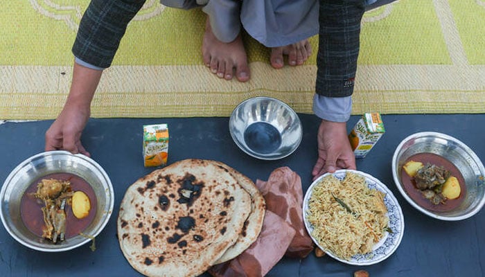 This representational image shows a person arranges plates of food during the Muslim holy month of Ramadan, at a mosque in Peshawar, Pakistan, February 19, 2026. — Reuters