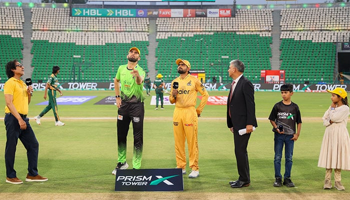 Lahore Qalandars skipper Shaheen Afridi (centre-left) flips the coin and Peshawar Zalmi captain Babar Azam (centre) makes the call during the toss for PSL 11 match at Gaddafi Stadium, Lahore, on April 25, 2026. — PSL