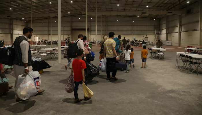 Special Immigrants from Afghanistan walk through the in-processing building after their evacuation at Camp As Sayliyah, Qatar, August 20, 2021.— Reuters/File