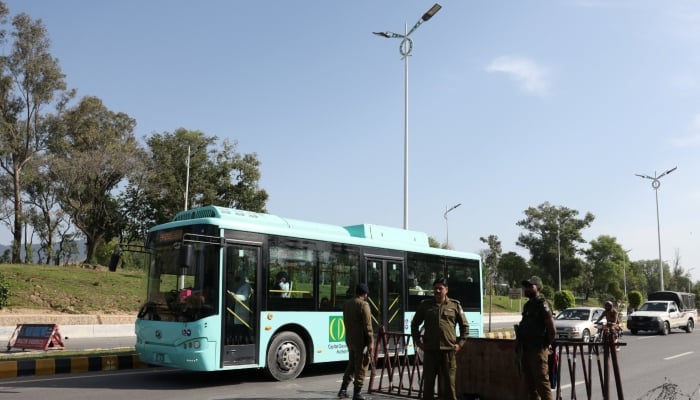 A bus moves past a security checkpoint along a road, as Pakistan prepares to host the US and Iran for the second phase of peace talks in Islamabad, April 19, 2026. — Reuters