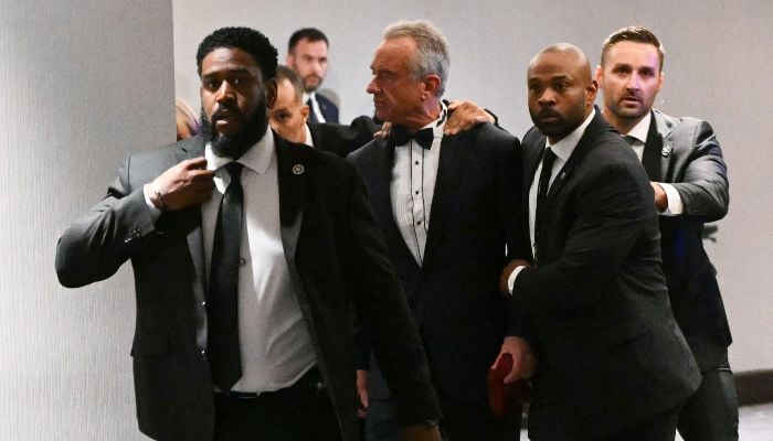 US Secretary of Health and Human Services Robert F. Kennedy Jr. is rushed out by Secret Service agents after loud bangs were heard during the White House Correspondents´ dinner at the Washington Hilton in Washington, DC, on April 25, 2026. — AFP