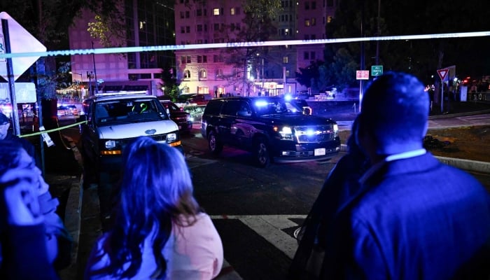 Vehicles are seen leaving the Washington Hilton after shots were heard during the White House Correspondents´ Dinner in Washington, DC, on April 25, 2026. — AFP