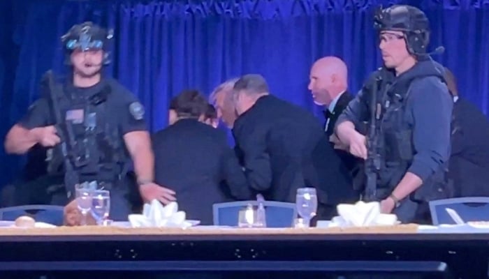US President Donald Trump is escorted out as a shooter opens fire during the annual White House Correspondents Association dinner in Washington, DC, US, April 25, 2026, in this screen capture from video. — Reuters