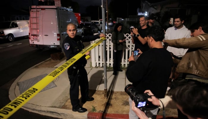 A police officer cordons off the area around the residence associated with Cole Tomas Allen, the suspect in the shooting incident at the annual White House Correspondents Association dinner in Washington, DC, in Torrance, California, US, April 25, 2026. — Reuters