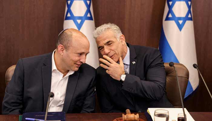 Israels Yair Lapid speaks with former prime minister Naftali Bennett during the weekly cabinet meeting in Jerusalem, September 18, 2022.— Reuters/File