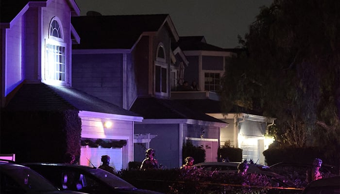 FBI tactical agents leave a house associated with the suspected White House Correspondents Dinner shooter after making entry at the residence in Torrance, California, late on April 25, 2026. — AFP