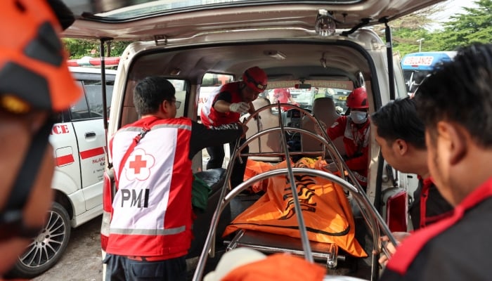 Rescuers and members of the Red Cross move a victim to an ambulance following a deadly collision between a commuter line train and a long-distance train, in Bekasi, on the outskirts of Jakarta, Indonesia, April 28, 2026. — Reuters