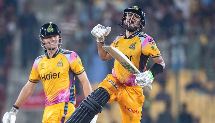Peshawar Zalmis Babar Azam (right) celebrates scoring his century during their PSL 11 Qualifier against Islamabad United at the National Bank Stadium in Karachi on April 28, 2026. — PSL
