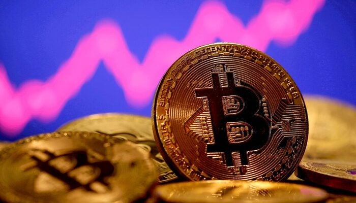 A representation of virtual currency Bitcoin is seen in front of a stock graph in this illustration taken January 8, 2021. — Reuters