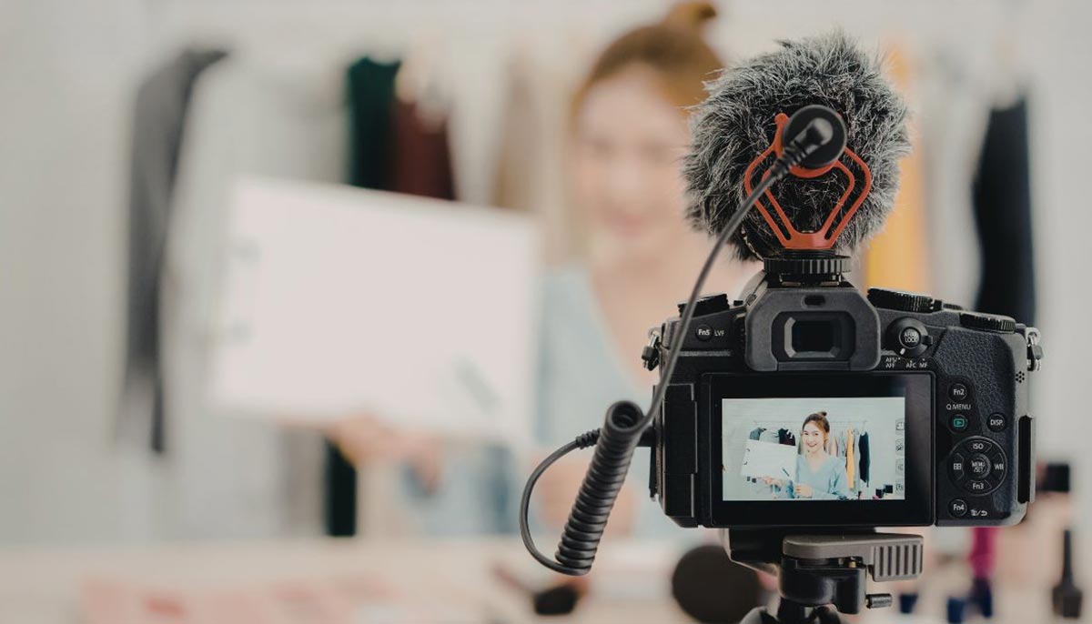 A representational image of a social media influencer filming content. — Canva