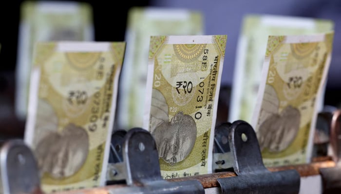 Indian twenty rupee currency notes are displayed at a roadside currency exchange stall in New Delhi, India, May 24, 2024. — Reuters