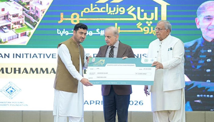 Prime Minister Shehbaz Sharif presents cheque to a beneficiary under “PM Apna Ghar Programme” in Islamabad on April 30, 2026. — PID
