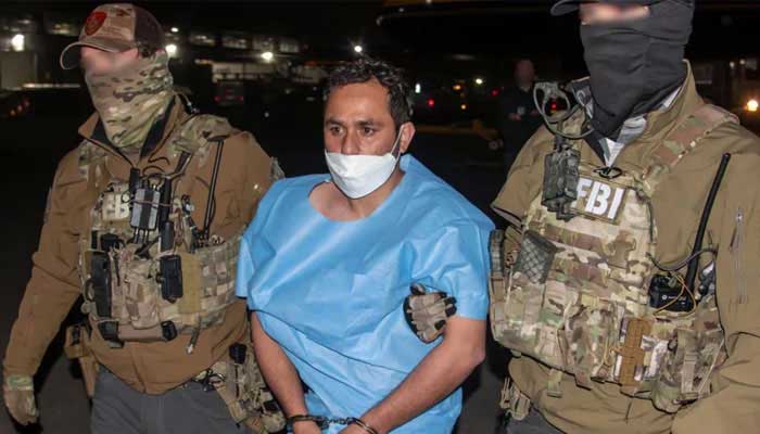 Daesh militant Mohammad Sharifullah being escorted by FBI personnel during his transfer to United States. — X@FBIDirectorKash