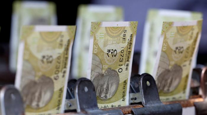 Indian rupee hits record low, puts central bank on defensive amid inflation fears