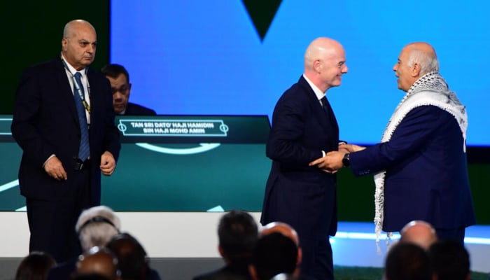 Fifa President Gianni Infantino (C) interacts with the President of the Palestine Football Association Jibril Rajoub as the Vice-President of Israel Football Association Basim Sheikh Suliman (L) looks on during a heated moment in the 76th FIFA Congress in Vancouver, Canada, on April 30, 2026. — AFP