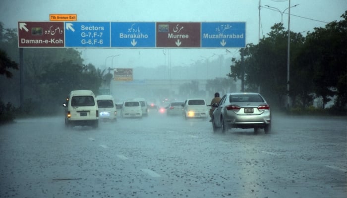 Commuters make their way at Srinagar Highway during heavy monsoon rains in Islamabad, July 21, 2025. — Online