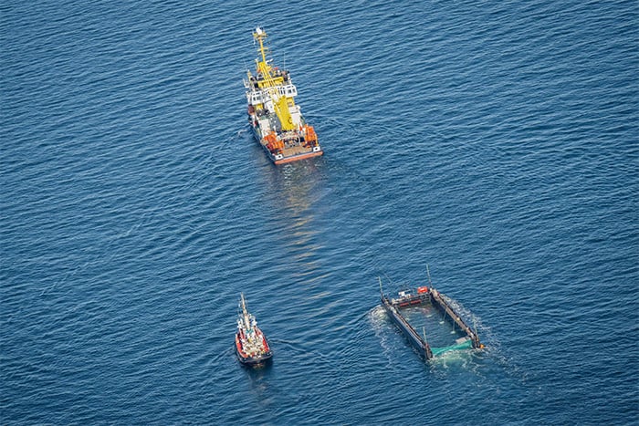 Aerial photo taken on April 29, 2026 shows the rescued humpback whale in a special barge along the Danish coastline enroute back to the North Sea after it beached on a sandbank near the city of Luebeck, in late March. — AFP