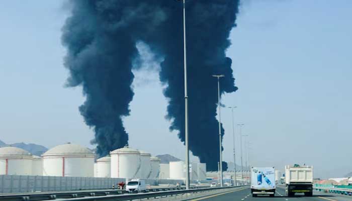 Smoke rises in the Fujairah oil industry zone, caused by debris after interception of a drone by air defenses, according to the Fujairah media office, amid the U.S.-Israel conflict with Iran, in Fujairah, United Arab Emirates, March 14, 2026. — Reuters