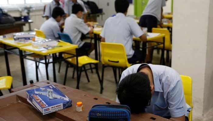 A student takes a break during a model aeroplane assembly enrichment class at a secondary school in Singapore. — Reuters/File