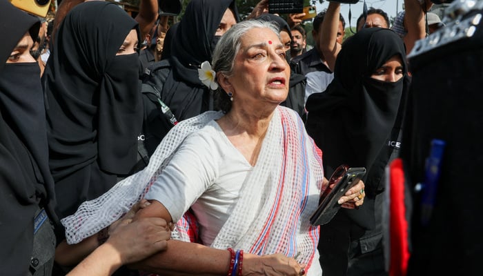 Women police officers detain a Pakistani artist and human rights activist Sheema Kirmani, an organiser of the Aurat March, outside Karachi Press Club, where she was scheduled to address a press conference on May 5, 2026. — Reuters