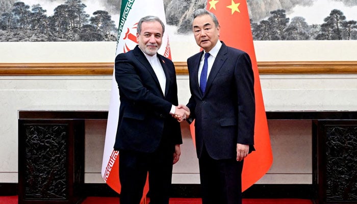 Chinese Foreign Minister Wang Yi and Iranian Foreign Minister Abbas Araqchi shake hands in Beijing, China, in this handout image released by Chinas Ministry of Foreign Affairs May 6, 2026. — Reuters