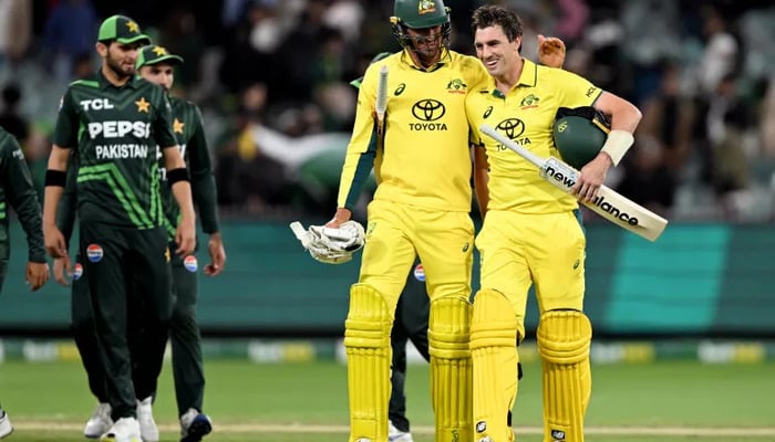 Pakistan and Australia cricketers walk back to the pavilion after a match in this undated image. — AFP