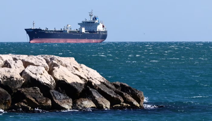 An oil tanker anchors near the oil hub of the port of Fos-Lavera at sunset near Marseille, southern France, April 14, 2026. — Reuters