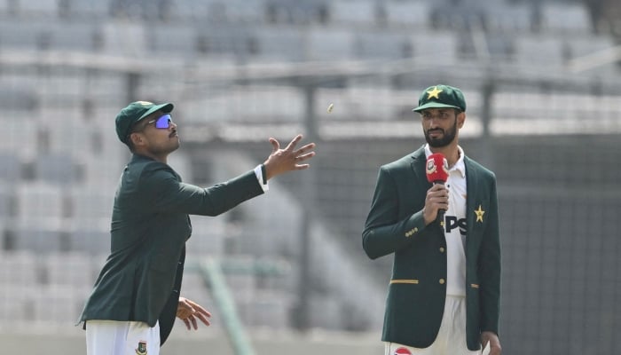 Bangladesh captain Najmul Hossain Shanto (left) tosses a coin as Pakistan captain Shan Masood looks on during the toss before the start of the first day of the first Test cricket match between Bangladesh and Pakistan at Sher-e-Bangla National Cricket Stadium in Dhaka on May 8, 2026. — AFP