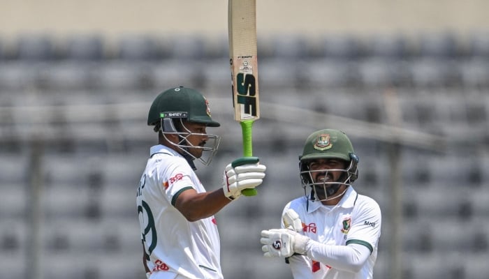 Bangladesh captain Najmul Hossain Shanto (left) reacts after scoring a half-century as his teammate Mominul Haque watches during the first test cricket match between Bangladesh and Pakistan at the Sher-e-Bangla National Stadium in Mirpur, Dhaka, May 8, 2026. — AFP