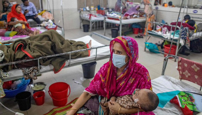 A woman holds a child diagnosed with measles inside a paediatric ward at the Bangladesh Shishu Hospital and Institute in Dhaka on May 6, 2026. — AFP