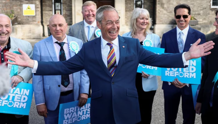 Britains Reform UK leader Nigel Farage reacts next to newly elected councillors at the Havering Town Hall, following the results of the local elections, in the London Borough of Havering, Britain, May 8, 2026. — Reuters