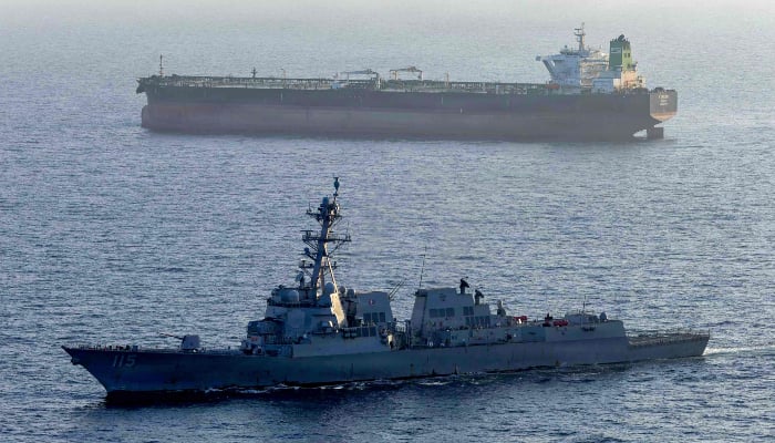 This US Navy handout photo released on May 7, 2026 by US Central Command Public Affairs, shows the Arleigh Burke-class guided-missile destroyer USS Rafael Peralta (DDG 115) implementing a maritime blockade against the Iran-flagged crude oil tanker vessel Stream while the latter was attempting to sail toward an Iranian port, on April 26, 2026. — AFP