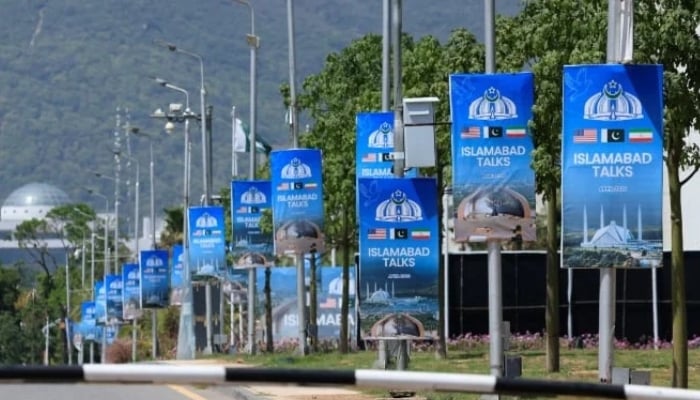 Hoardings are mounted on lamp posts, as Pakistan prepares to host the US and Iran for a possible second phase of talks in Islamabad, April 20, 2026. — Reuters